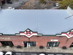 Commercial building with newly installed metal roofing system replacing an aging metal roof to improve durability, weather resistance, and long-term building protection.