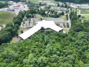 Aerial view of Freedom Trail School in Newland, NC featuring a newly installed white TPO commercial roofing system designed for energy efficiency, weather protection, and long-term durability.