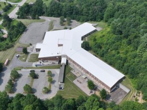 Drone view of Freedom Trail School in Newland, North Carolina showcasing its newly completed white TPO commercial roof designed for superior weather resistance and energy savings.