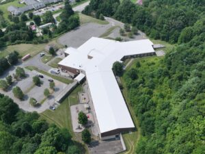 Aerial photograph of Freedom Trail School's new white TPO membrane roof in Newland, NC providing long-lasting commercial roofing protection and improved energy efficiency.